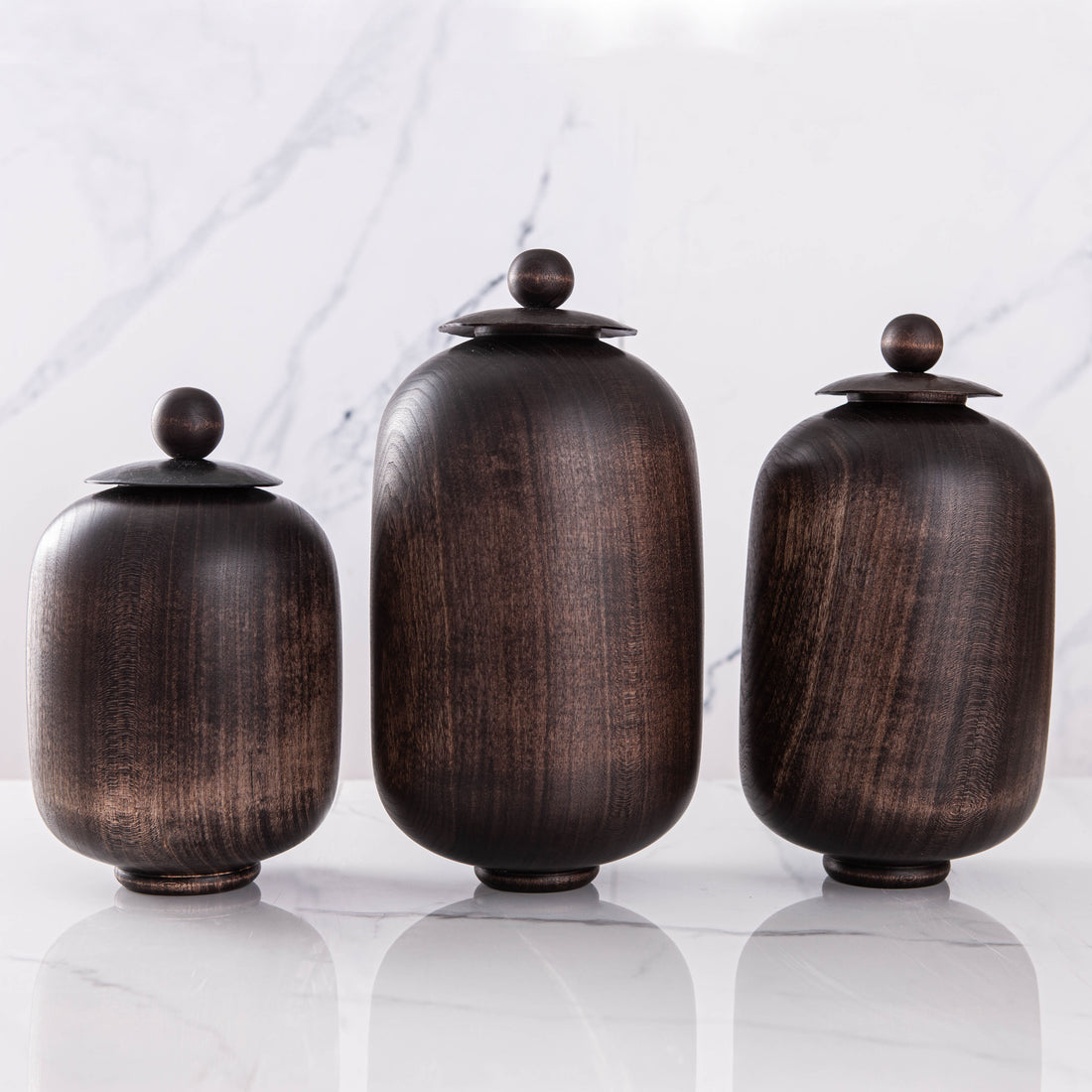 SET OF THREE LIDDED VESSELS IN EBONIZED CHERRY AND WAXED STEEL