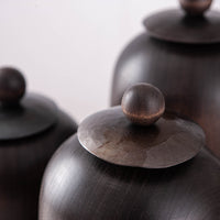 SET OF THREE LIDDED VESSELS IN EBONIZED CHERRY AND WAXED STEEL