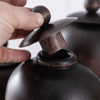 SET OF THREE LIDDED VESSELS IN EBONIZED CHERRY AND WAXED STEEL
