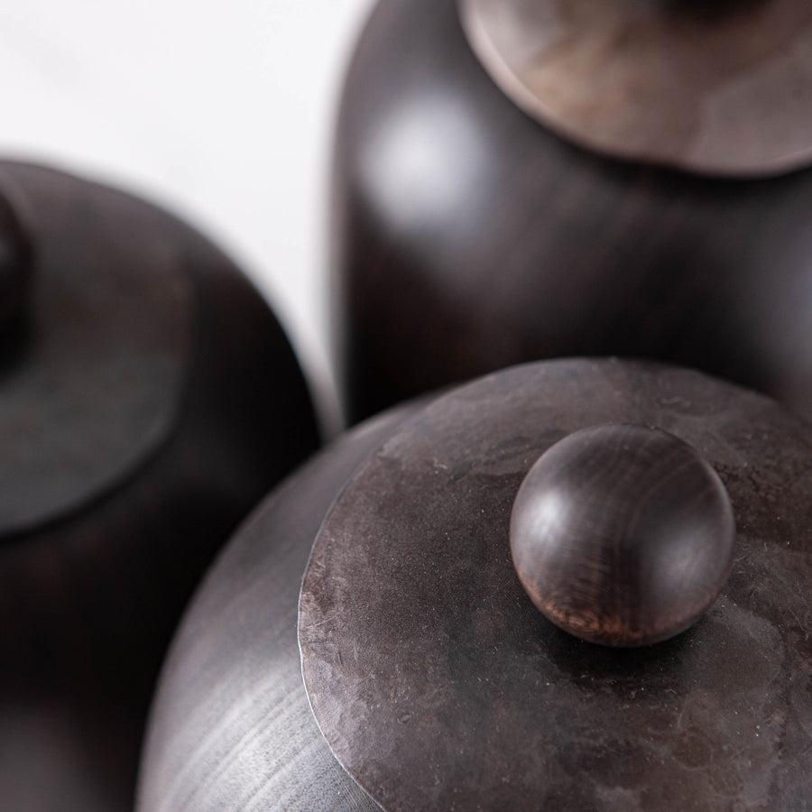 SET OF THREE LIDDED VESSELS IN EBONIZED CHERRY AND WAXED STEEL